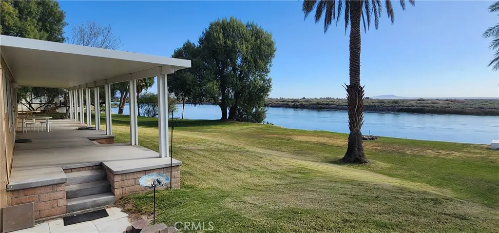 Landscaped front lawn and riverfront view