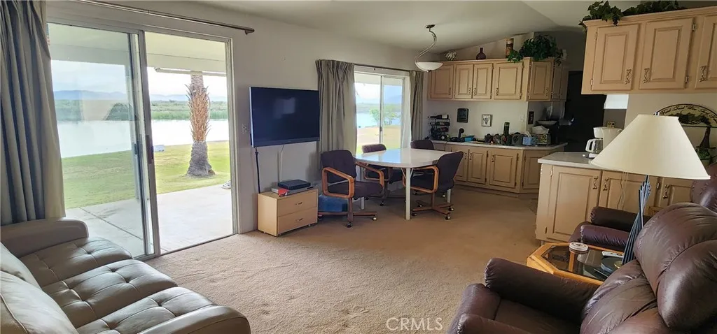 Living room and dining area have riverfront views