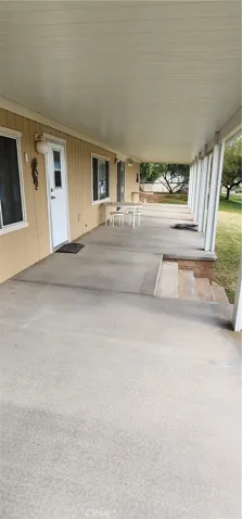 Covered front patio has full riverfront view
