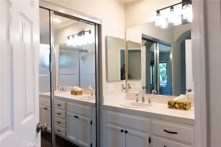 Primary Bathroom vanity and mirror closet doors