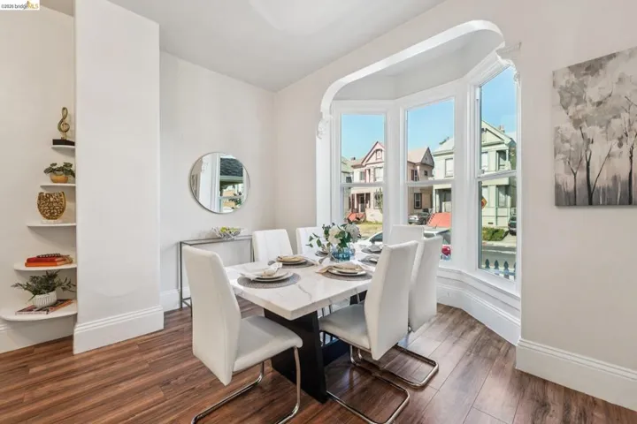 Dining space featuring dark wood-style flooring and baseboards