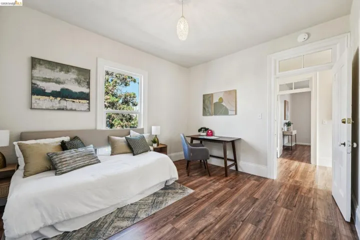 Bedroom featuring dark wood finished floors and baseboards