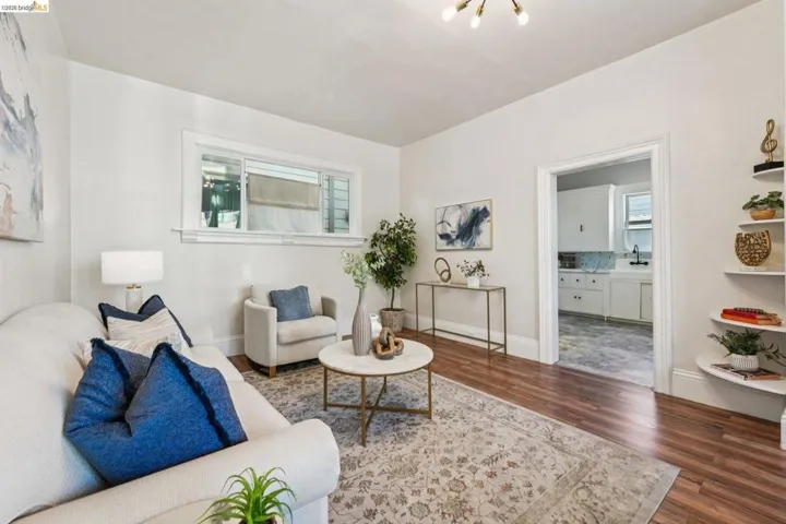 Living room with dark wood-style flooring and baseboards