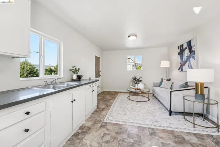 Living room featuring stone finish flooring and baseboards