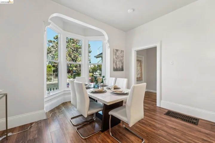 Dining area with dark wood-type flooring