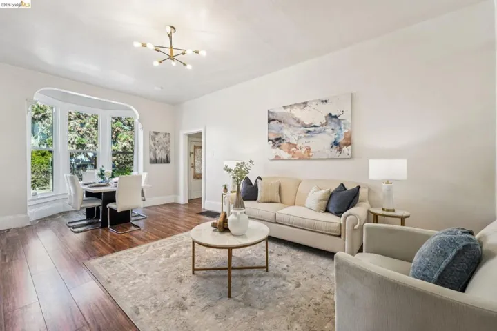 Living room featuring a chandelier and wood-type flooring