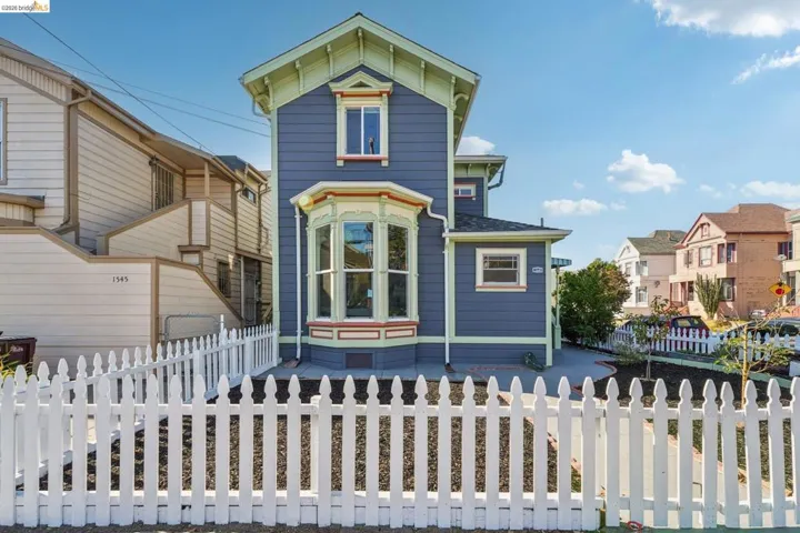 Italianate-style house featuring a fenced front yard