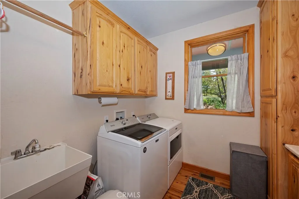 Main Level Laundry Room With Laundry Chute And Utility Sink