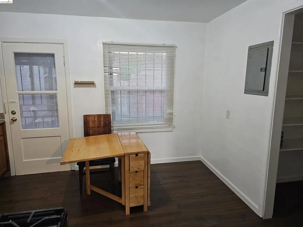 Open concept room featuring dark wood-finish flooring
