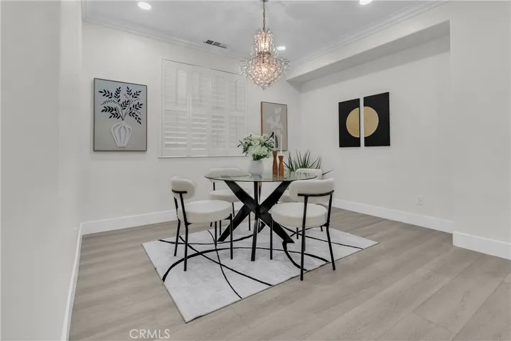 DINING AREA WITH PLANTATION SHUTTERS & CHANDELIER