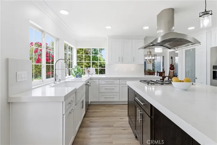 Bright kitchen with quartz countertops, farmhouse sink, and serene garden views.