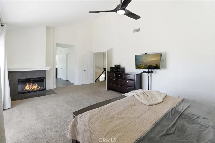 Light-filled primary suite with a fireplace, generous layout, and direct access to a private deck.