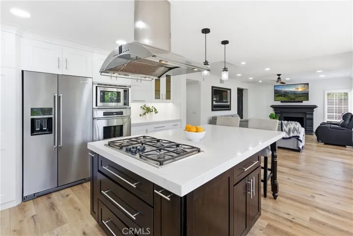 Beautifully updated kitchen featuring a spacious island, stainless steel appliances, and open-concept living.