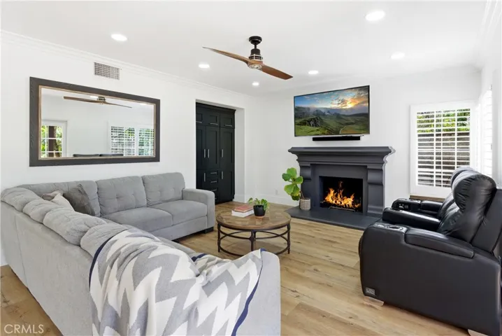 Inviting living room centered around a stylish fireplace with abundant natural light.