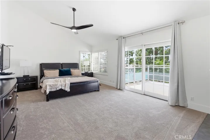 Light-filled primary suite with a fireplace, generous layout, and direct access to a private deck.