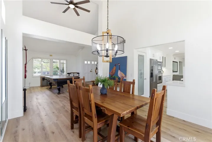 Light-filled dining area with soaring ceilings, expansive windows, and seamless indoor-outdoor flow.