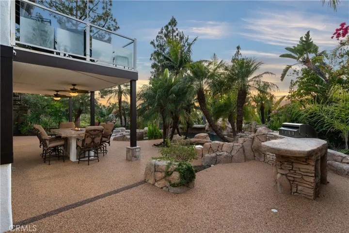 Entertainer’s backyard with multiple seating areas and a newer built-in BBQ.