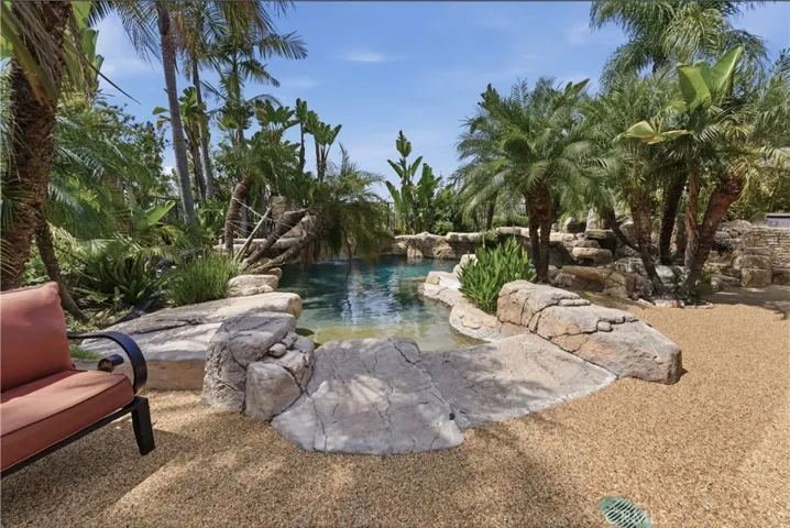 Private backyard retreat featuring a custom rock pool, spa, and cascading waterfalls.