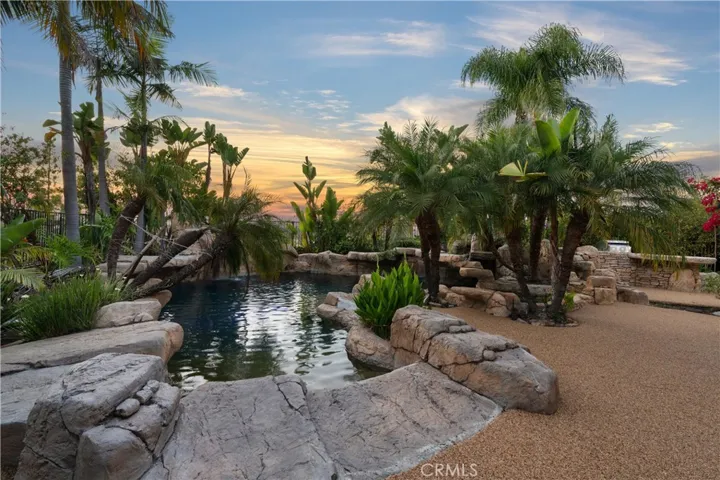 Private backyard retreat featuring a custom rock pool, spa, and cascading waterfalls.
