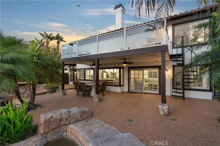 Entertainer’s backyard with multiple seating areas and a newer built-in BBQ.