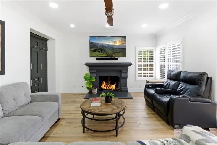 Inviting living room centered around a stylish fireplace with abundant natural light.