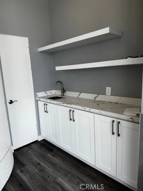 Wet bar in living room with additional storage