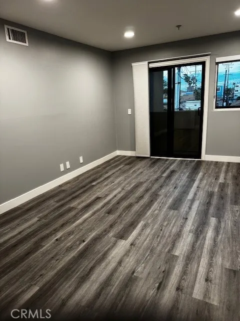 Primary bedroom with small private balcony