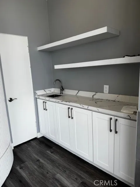 Wet bar in living room with additional storage