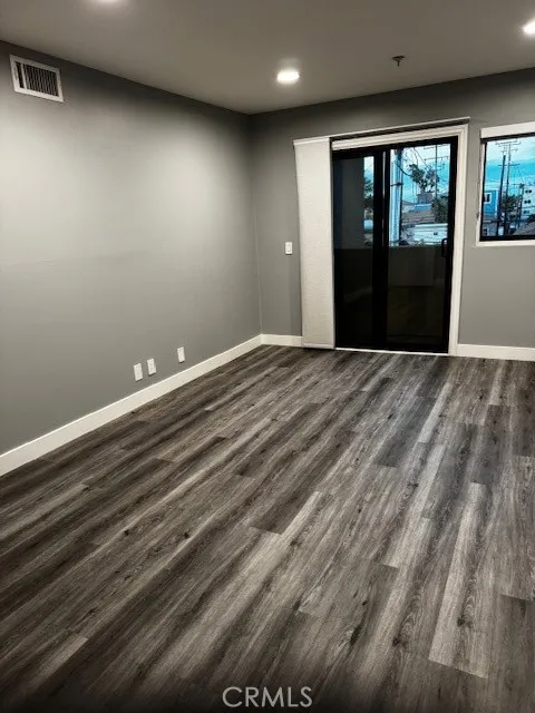 Primary bedroom with small private balcony