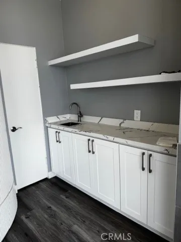Wet bar in living room with additional storage