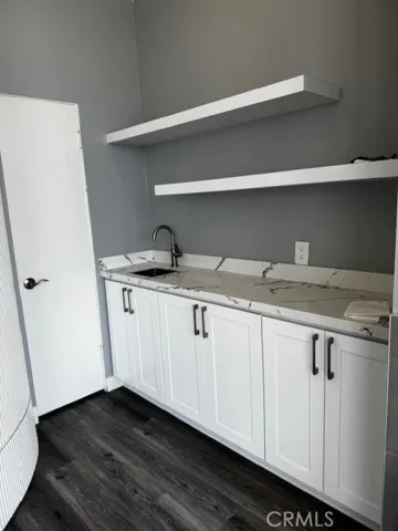 Wet bar in living room with additional storage