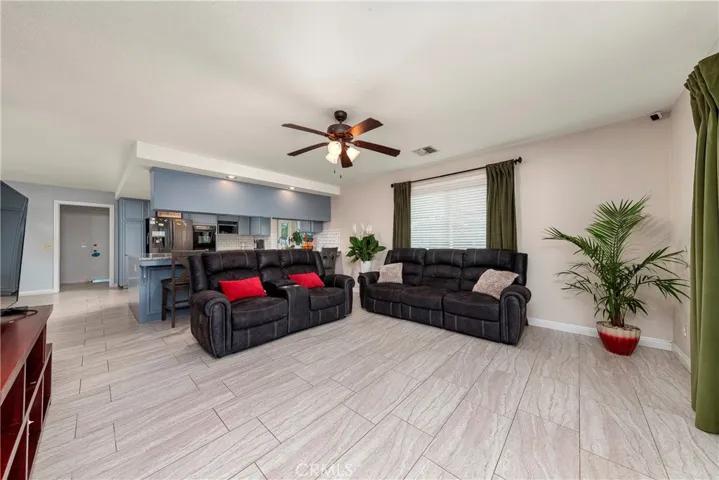 family room opens to the kitchen and glass doors leading outside.
