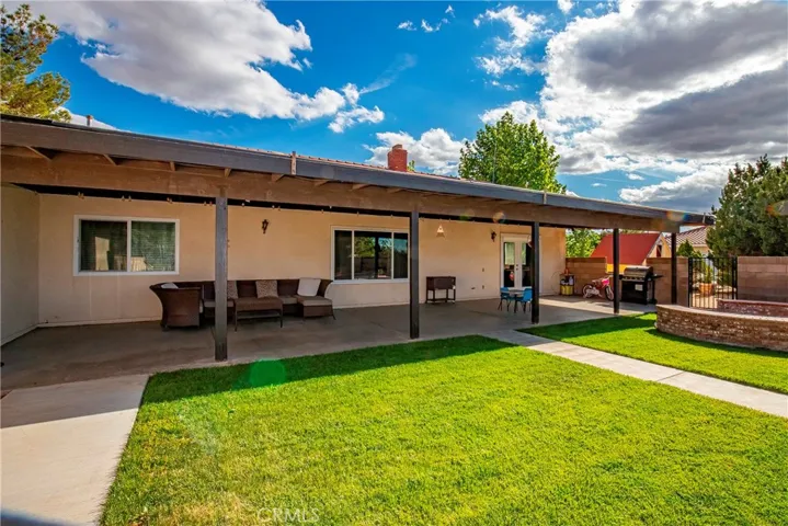 covered patio and grass area by the pool
