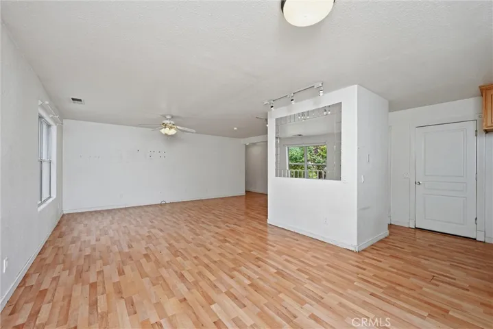 Dining area and living area with kitchen to the right.