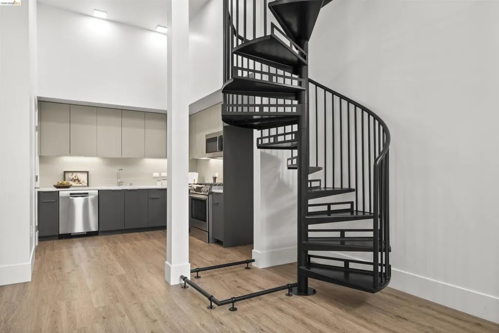 Stairs featuring a towering ceiling and wood finished floors