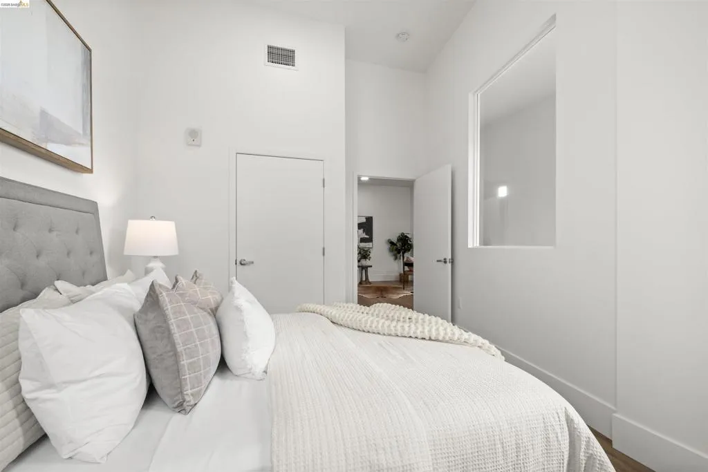 Bedroom with baseboards and wood finished floors