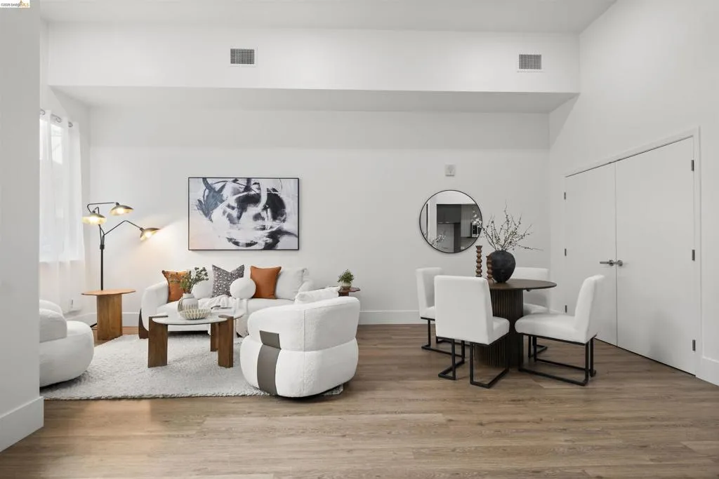 Living area with wood finished floors and baseboards