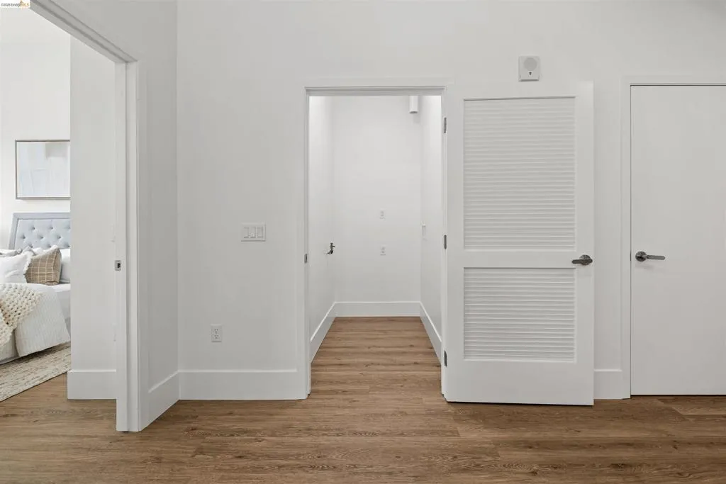 Hallway with wood finished floors and baseboards