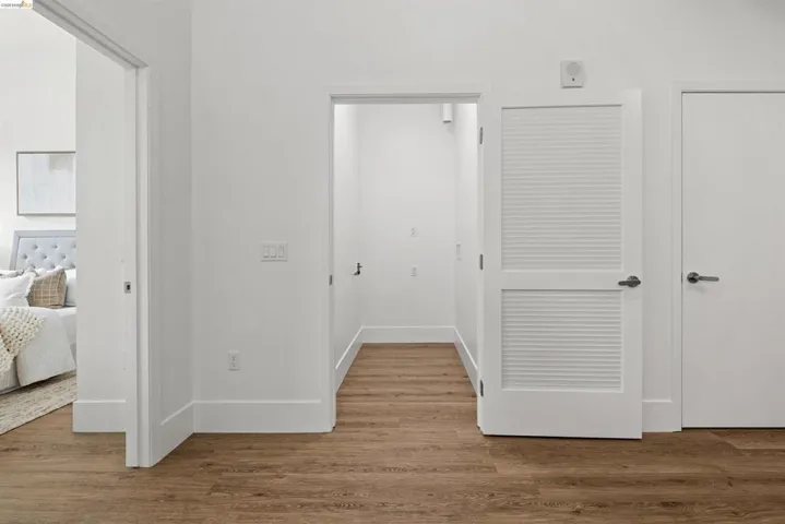 Hallway with wood finished floors and baseboards