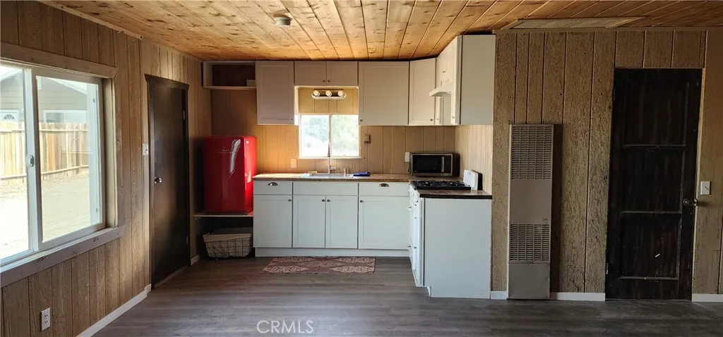 Full kitchen with refrigerator, stove, microwave and sink