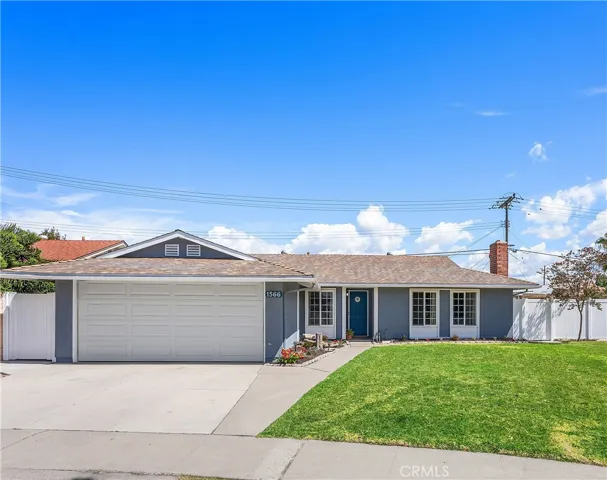 Single-story ranch home with fresh gray exterior, blue front door, large windows, and excellent curb appeal.