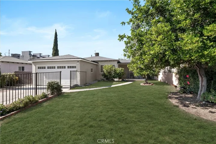 Large gated front yard. there is no grass. (Grass is AI generated) but You could add it and it would be Gorgeous!
