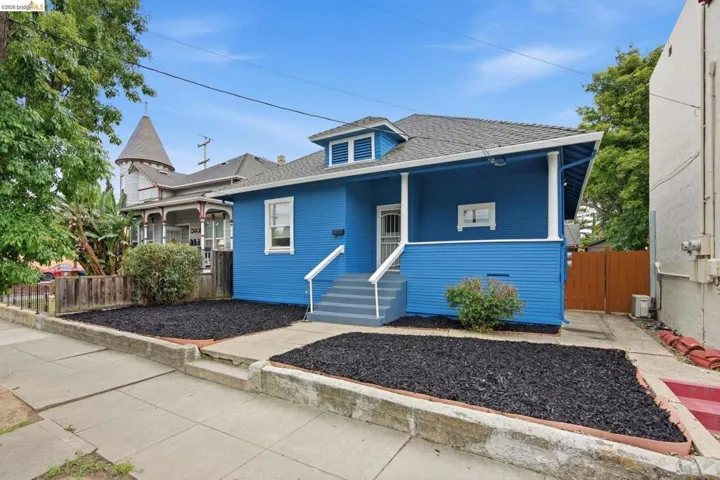 Vibrant blue exterior with white trim accents and a covered front porch