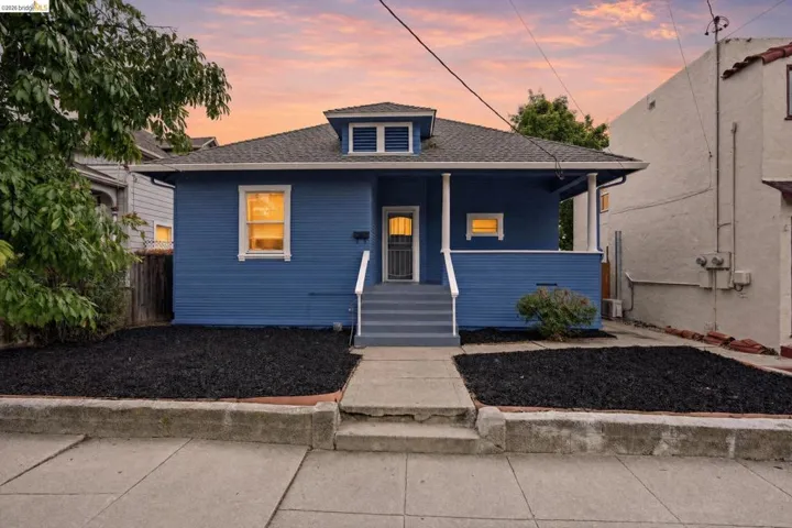 Blue clapboard exterior with white trim and a covered porch