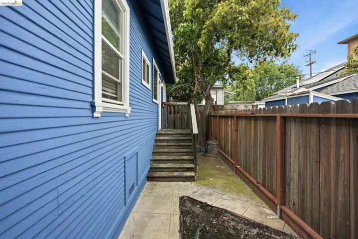 Exterior siding in a vibrant blue finish with white trim windows
