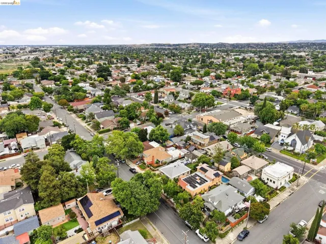 Aerial perspective of a residential neighborhood featuring tree-lined streets and established homes