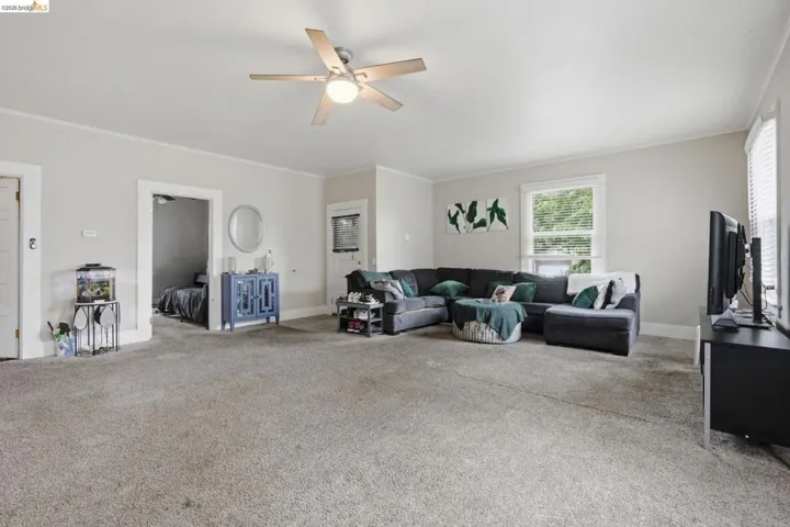 Spacious room featuring neutral carpeting and light-toned walls