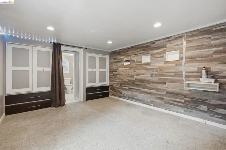 Textured wood-finish accent wall with integrated shelving