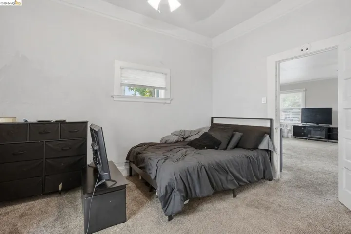 Spacious interior with neutral carpeting and a single window
