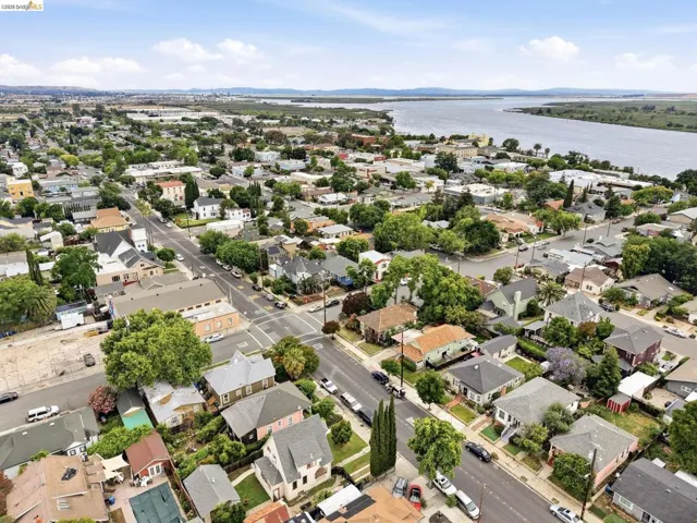 Established residential area featuring a variety of architectural styles, tree-lined streets, and a waterfront backdrop